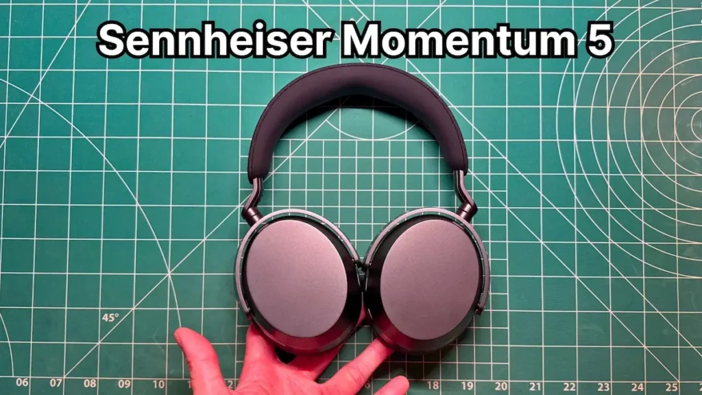 Close-up of a person holding the Sennheiser Momentum 5 wireless headphones.