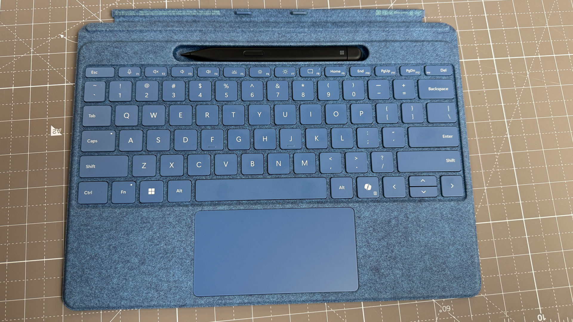 Close-up of the Surface Pro Flex Keyboard and the Slim Pen 2 charging in its cradle.