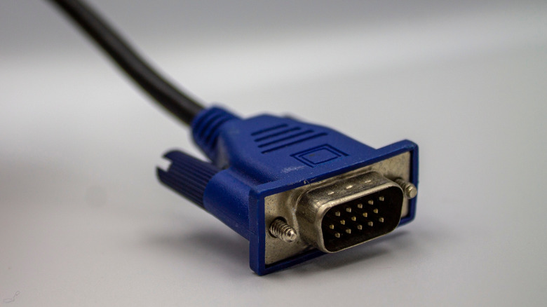 A close-up of a blue 15-pin male VGA connector.