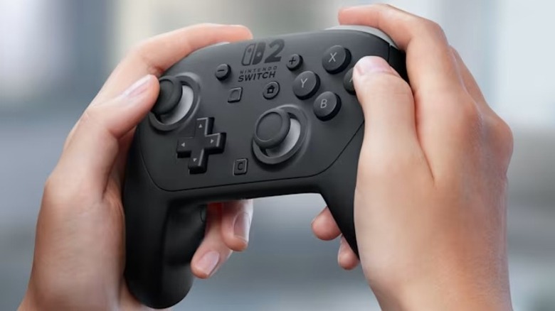 Close-up view of a player's hands holding the official Nintendo Switch 2 Pro Controller.