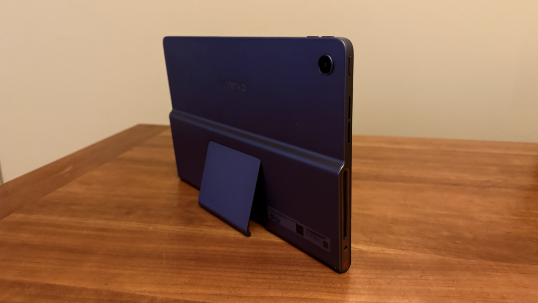 Lenovo Tab Plus standing on its own using the built-in metal kickstand.