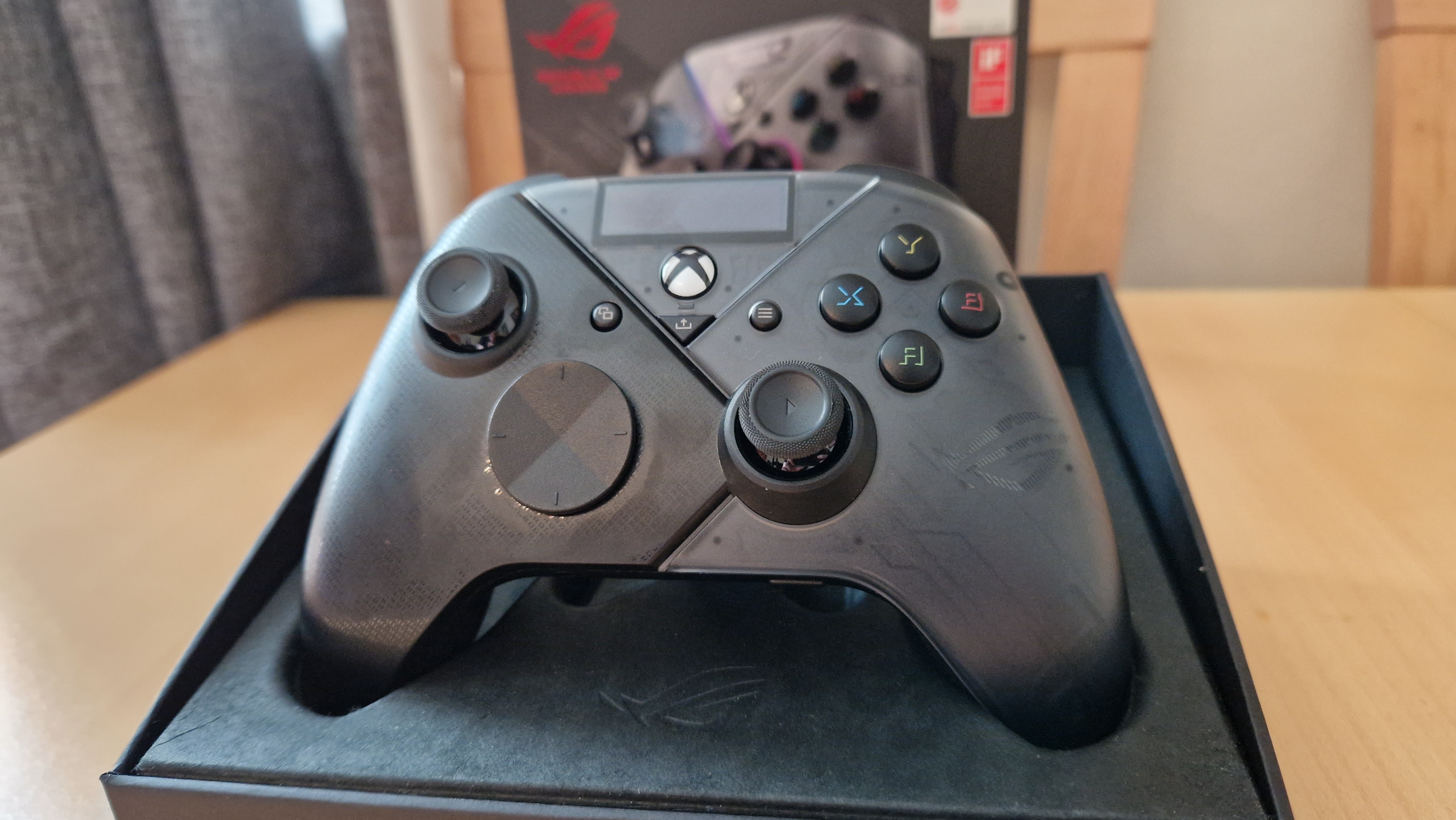 Macro shot of the Asus ROG Raikiri Pro controller showcasing its built-in OLED screen.