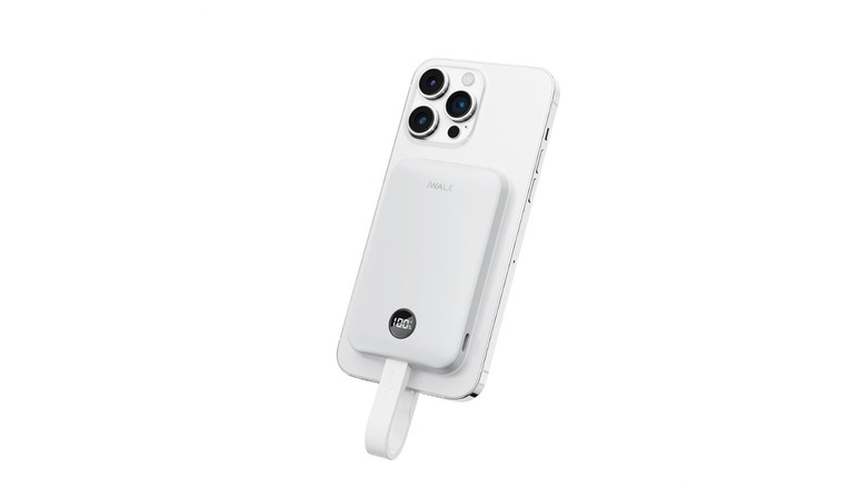 A compact white iWalk magnetic power bank attached to the back of a smartphone.