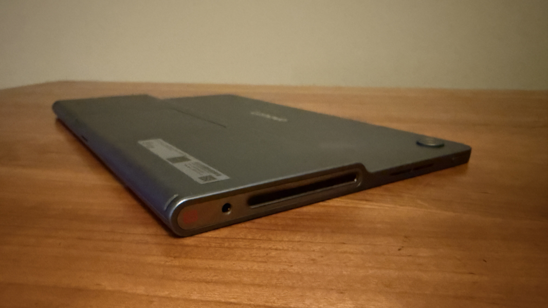 Side profile view showing the thickness of the Lenovo Tab Plus speaker box versus the thin top half.