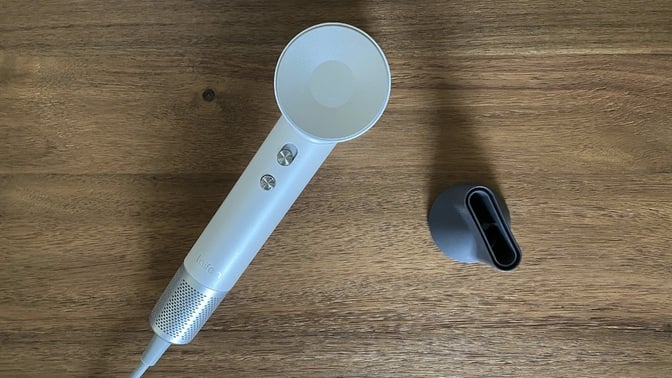 The white Laifen Swift high-speed hair dryer with a magnetic concentrator nozzle.