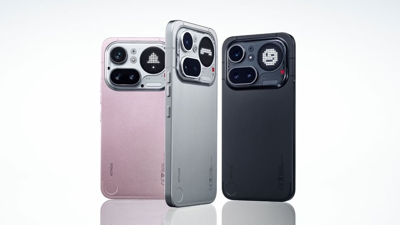 Three Nothing Phone 4a Pro units in different colors standing upright to show their transparent back panels.