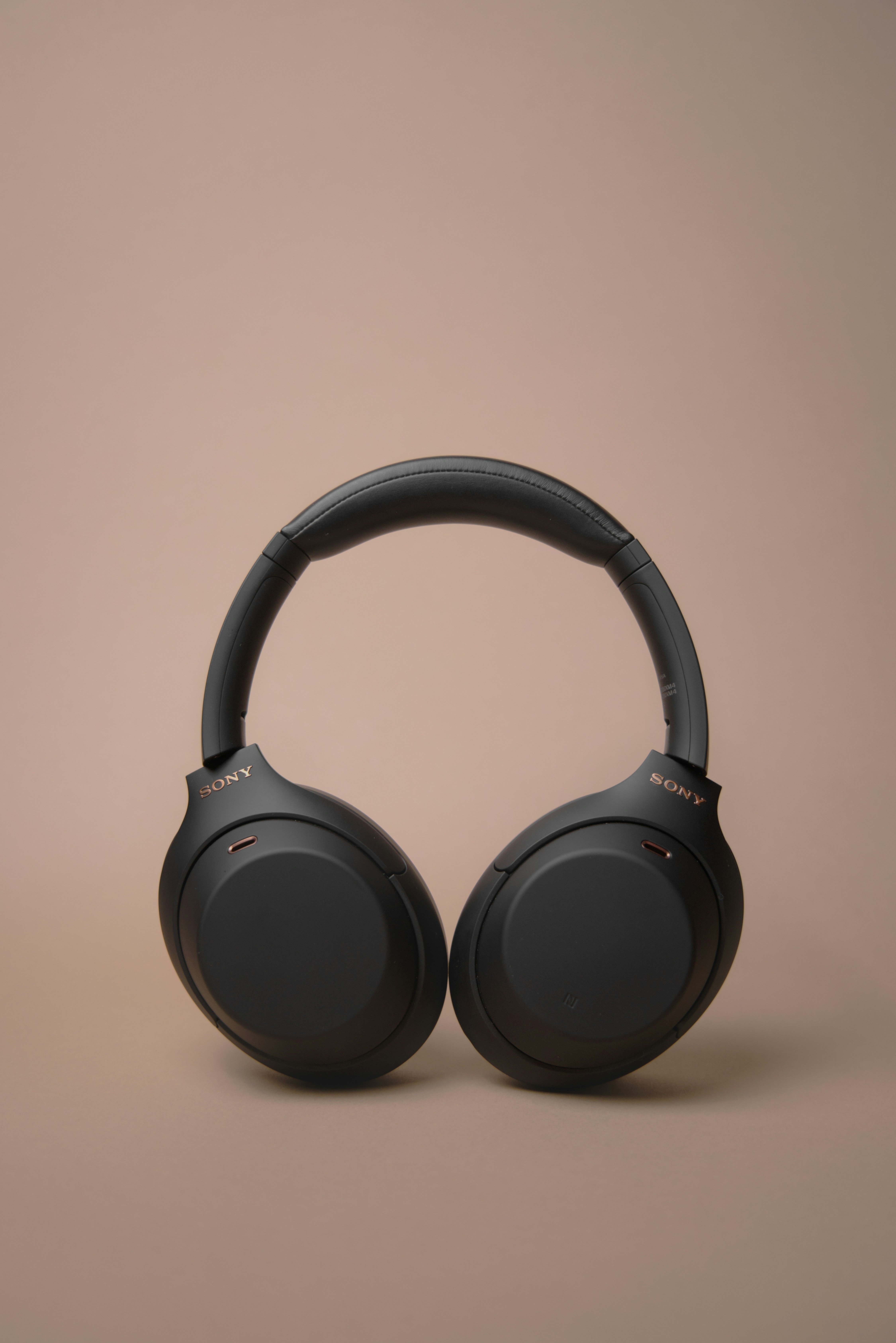 Sleek wireless noise-canceling headphones sitting on a desk.