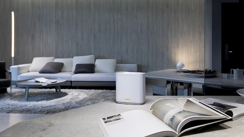 The Asus ZenWiFi AX node placed on a table in a modern living room setting.