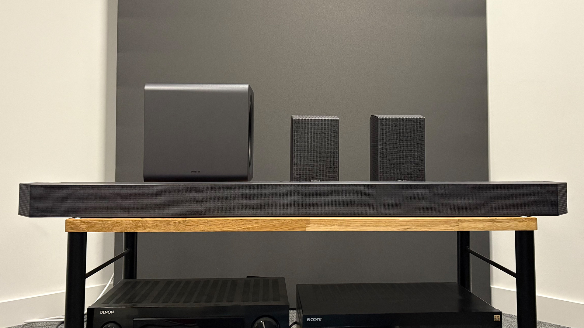A Samsung soundbar system with a wireless subwoofer and dedicated rear surround speakers.