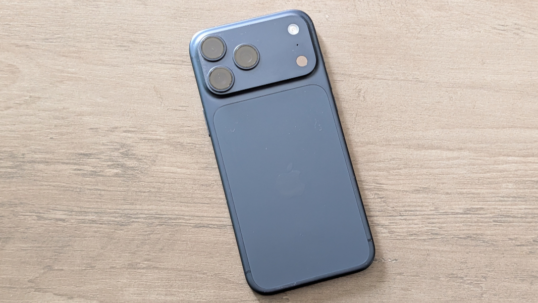 The iPhone 17 Pro Max in its signature Deep Blue color showing the rear glass and camera setup.