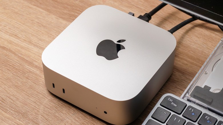 An Apple Mac Mini M4 positioned neatly on a minimalist wooden desk.