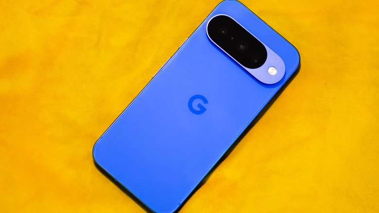 Top down view of the Google Pixel 10 on a yellow surface.
