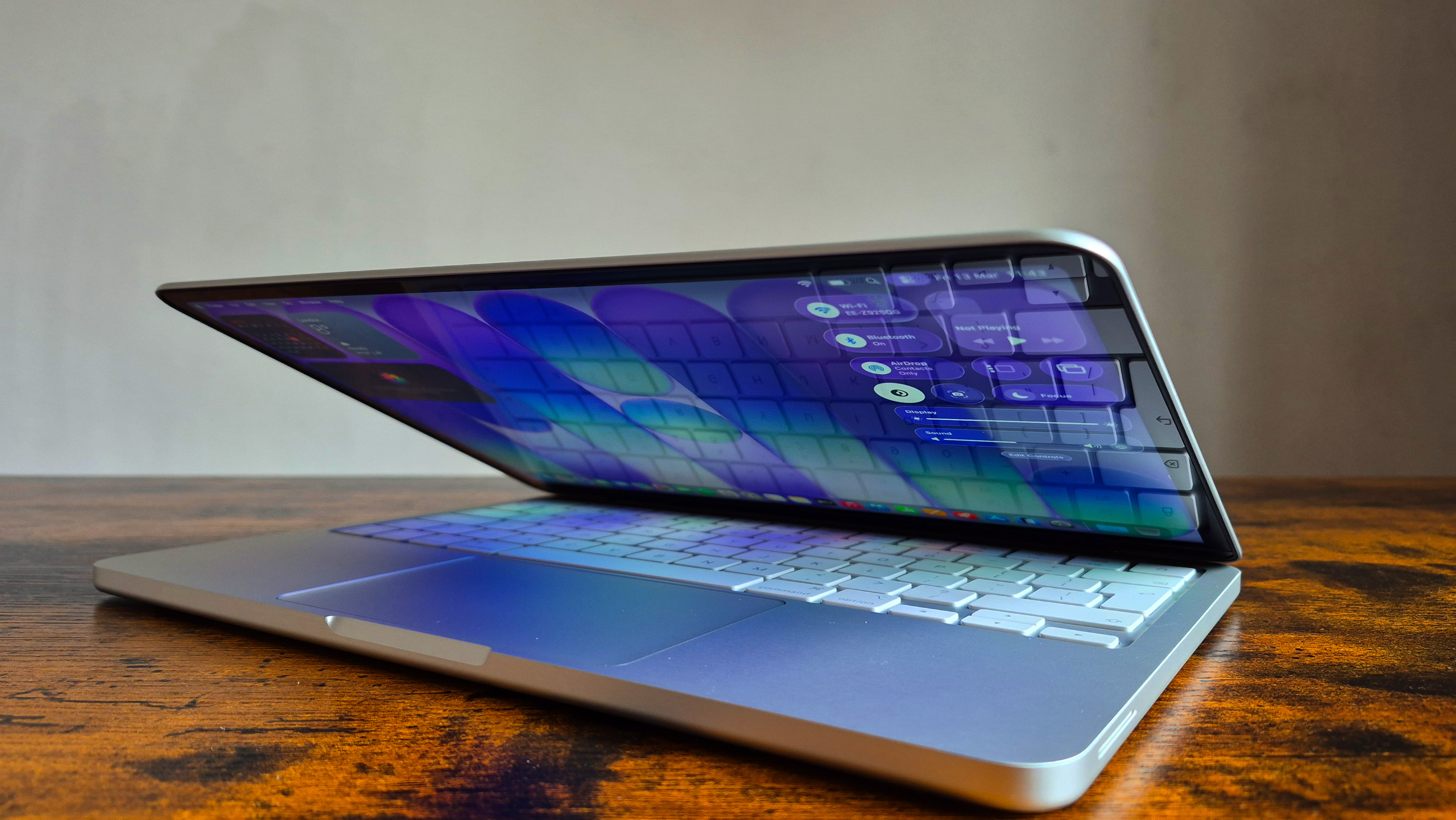 Side profile of the MacBook Neo emphasizing its 12.7mm thin aluminum chassis.