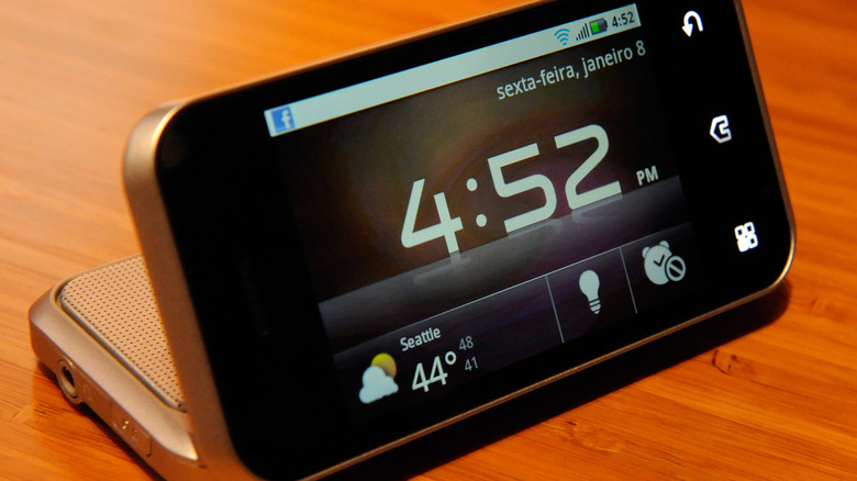 Motorola Backflip phone resting on a surface with its screen flipped back to reveal the physical keyboard on the base.