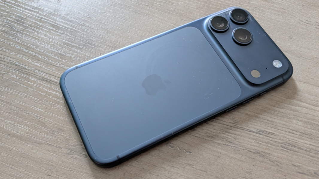 Rear view of an iPhone with an aluminum unibody and a visible two-tone MagSafe charging area.