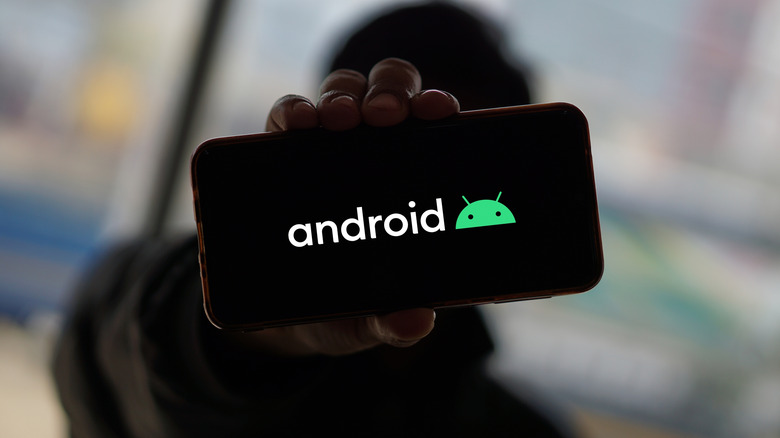 Close-up of a smartphone with the Android logo.