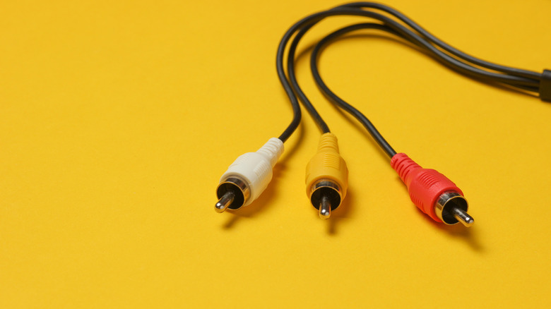 Standard yellow, white, and red composite RCA cables for analog video and audio.