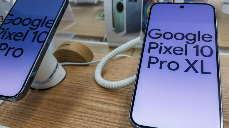 The Google Pixel 10 Pro and Pro XL devices on display in a brightly lit retail environment.