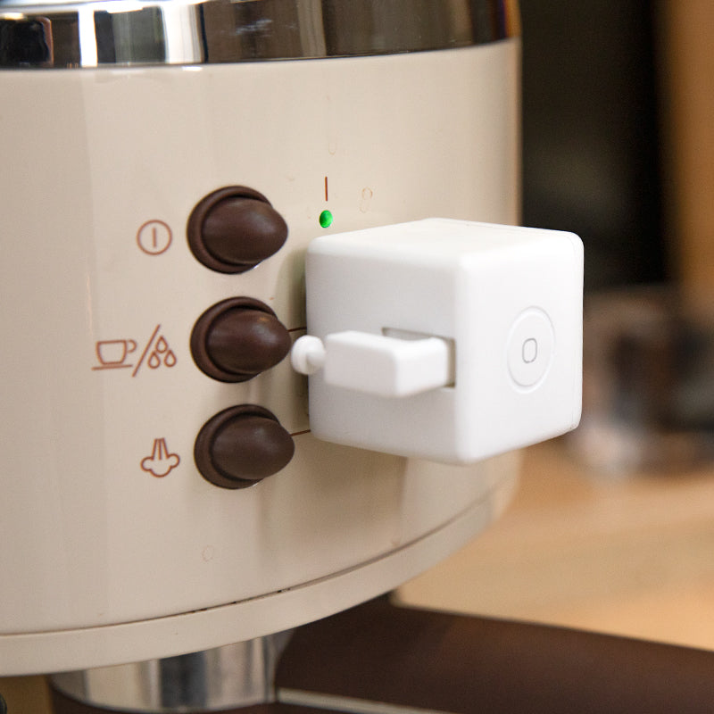 Fingerbot Plus smart button pusher automating a coffee maker button.