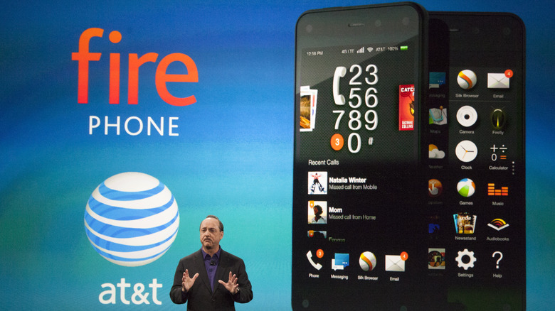 A large-scale product reveal event featuring the Amazon Fire Phone displayed on a giant screen during a keynote.