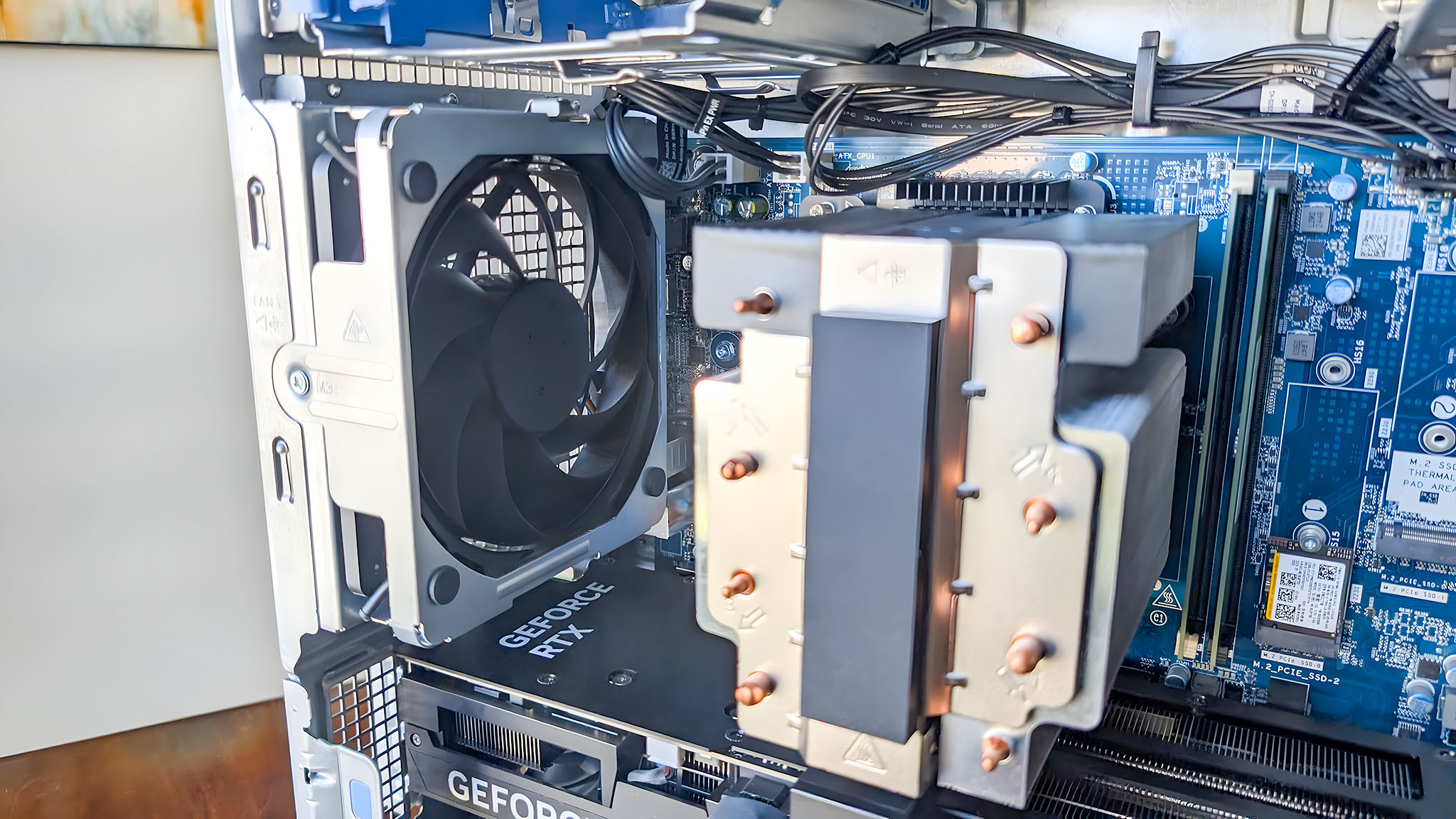 Close-up internal view of a desktop cooling fan and motherboard components.