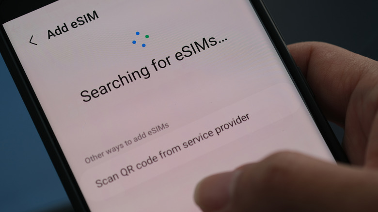 A close-up of a smartphone screen showing the 'Add eSIM' interface and searching for profiles.