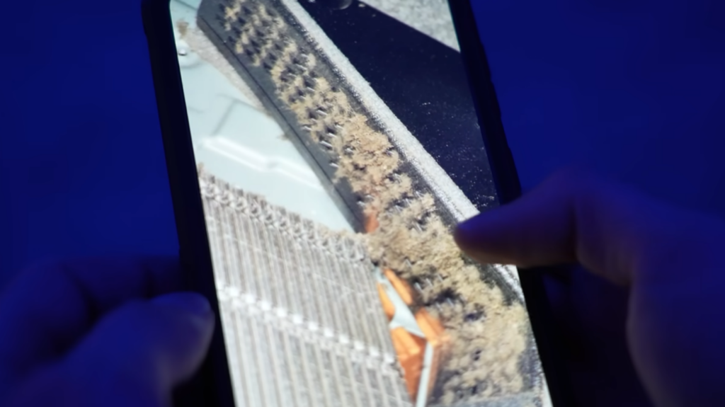 Illustration showing dust particles and lint clogging the intake vents of a console.