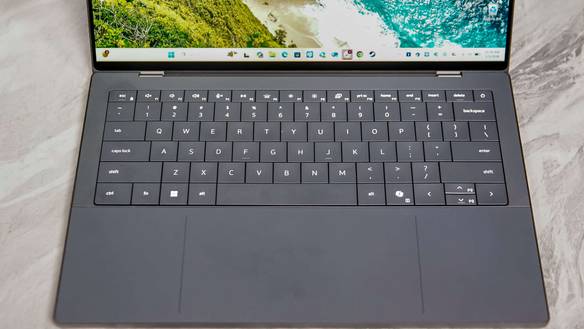 A top-down view of the Dell XPS 14 keyboard deck showing physical function and escape keys.