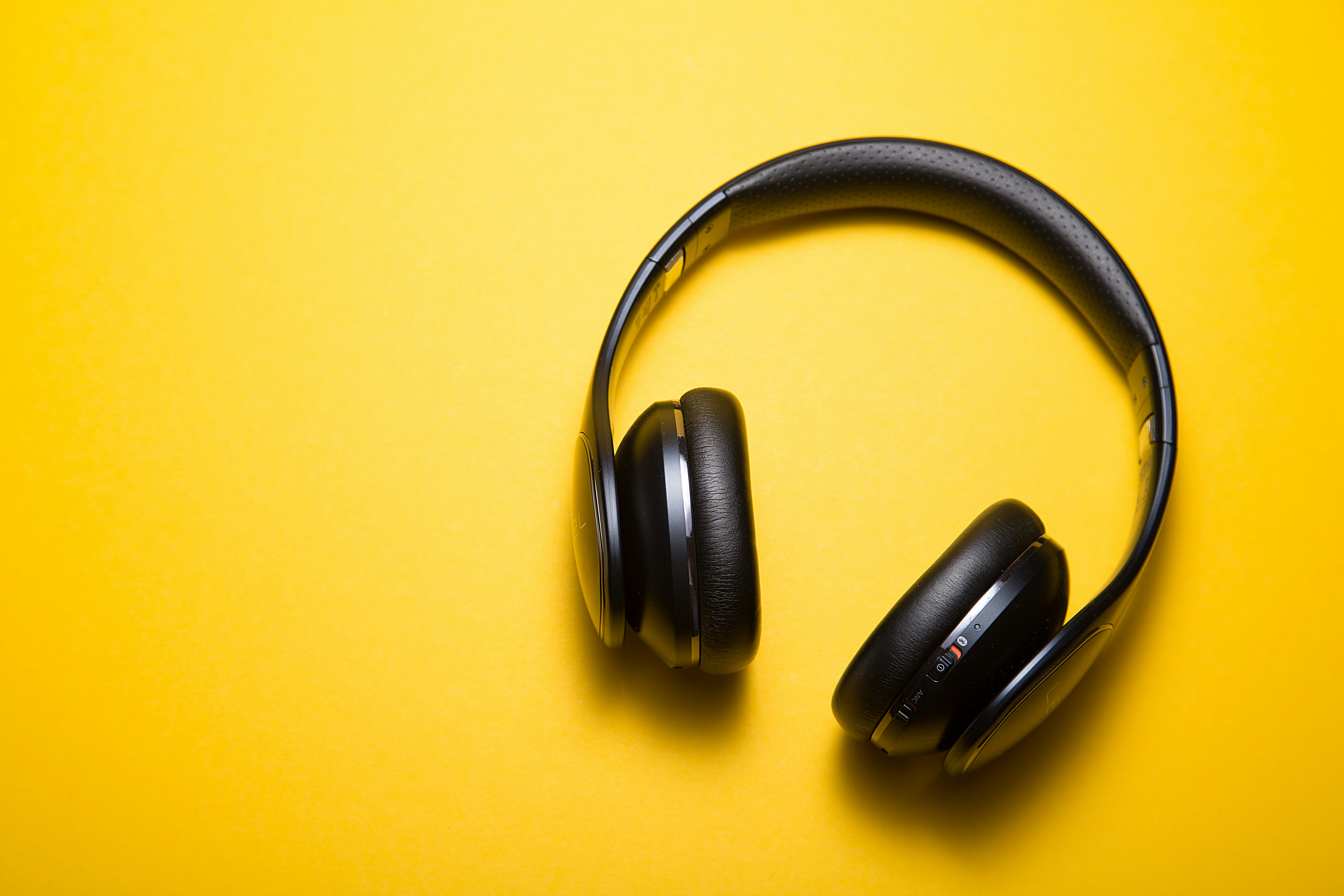 Old wired headphones with worn-out earpads.