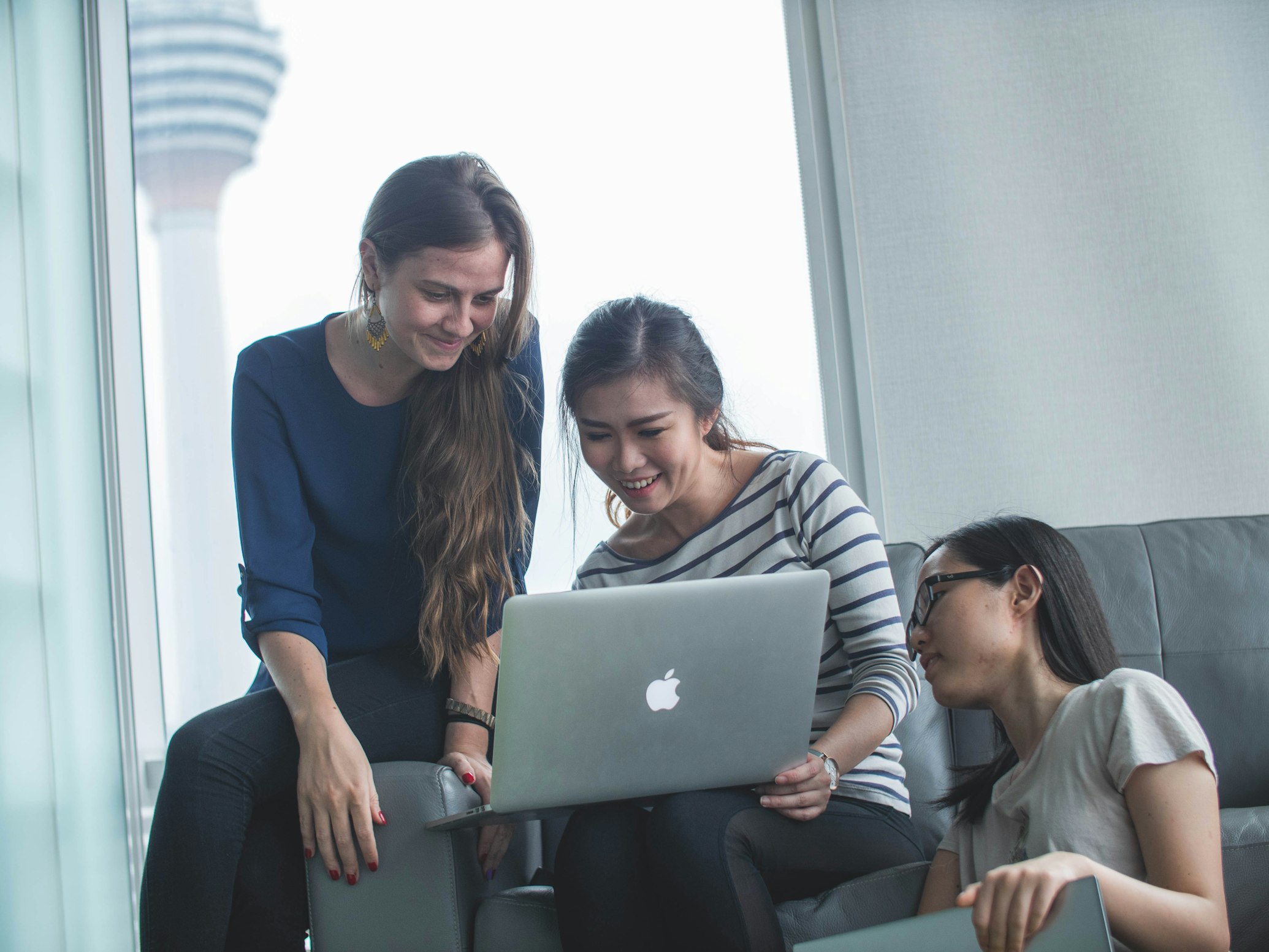 Customers inside a sleek, modern Apple retail store environment.